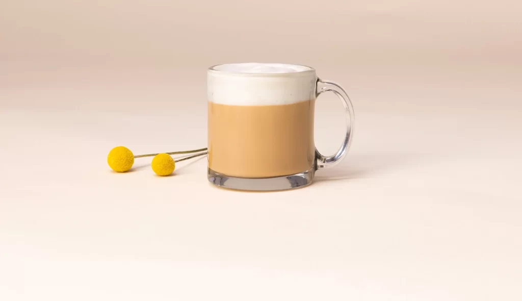 Blonde Vanilla Latte in a Mug placed on a plain surface