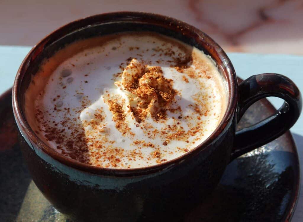 coconut coffee topped with cocoa and cinnamon powder