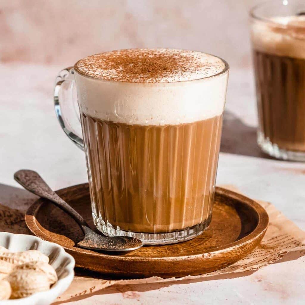 coffee in a mug with peanut butter and cocoa mix on top