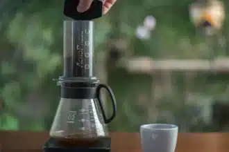 a person making coffee using an aeropress machine