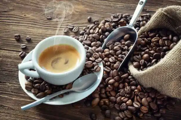 a cup of red eye coffee placed on a plate with a spoon coffee beans scattered on a surface