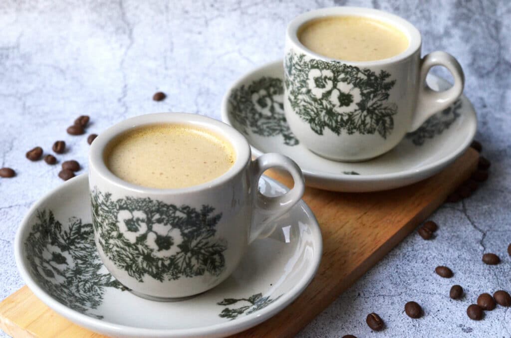 cups of white coffee placed on saucers