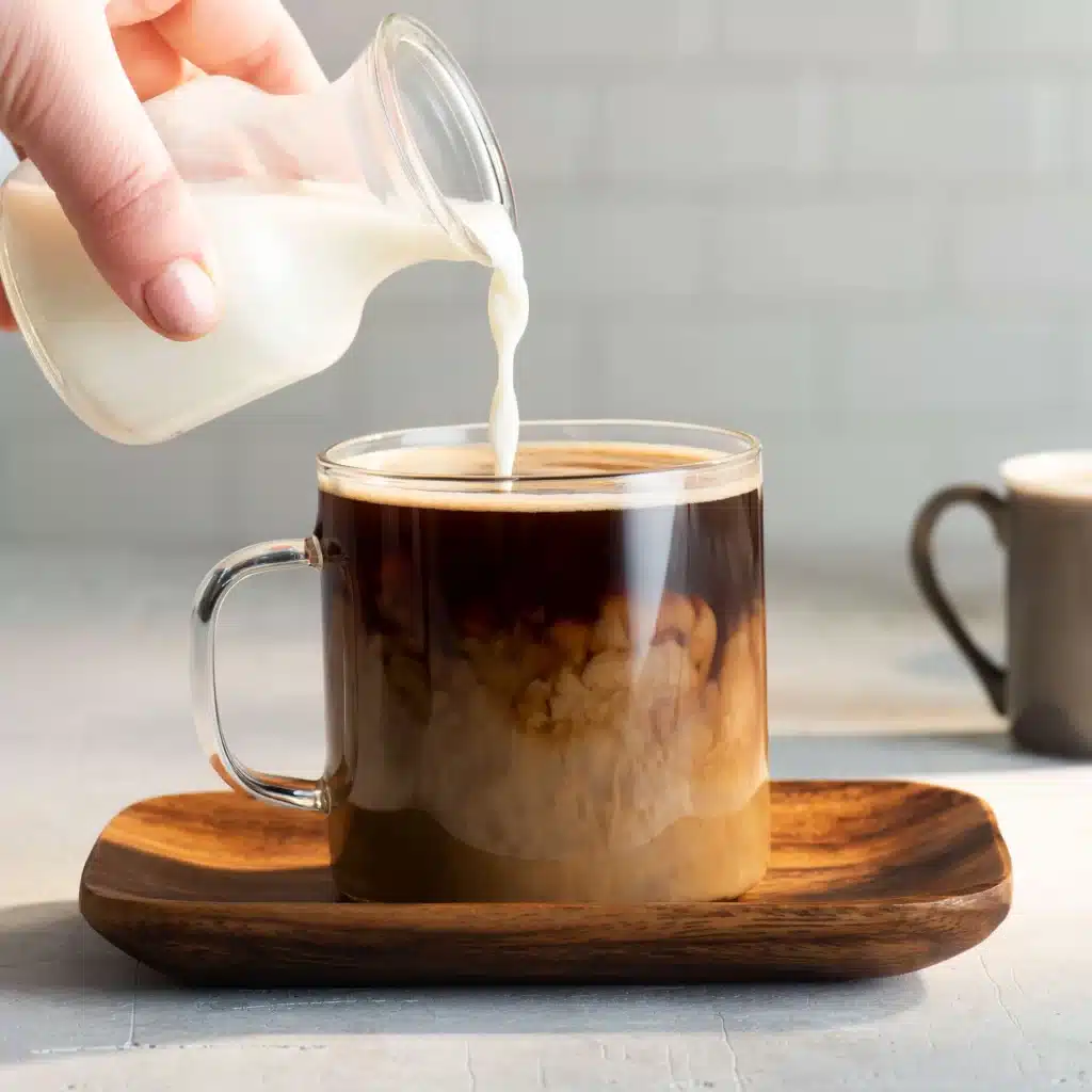 zoomed in view of a female hand pouring milk into a mug of coffee placed on a wooden saucer