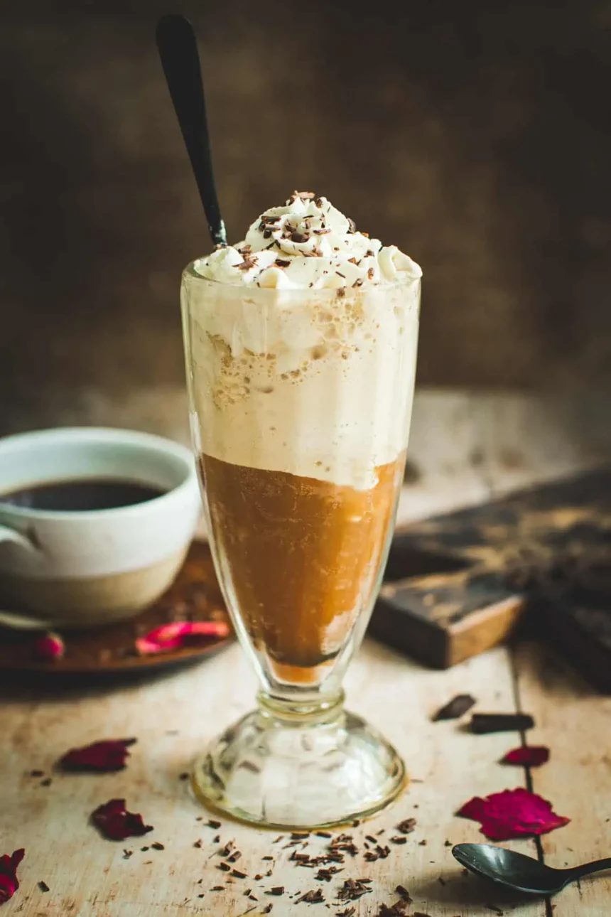 a glass of frozen coffee placed on wooden surface