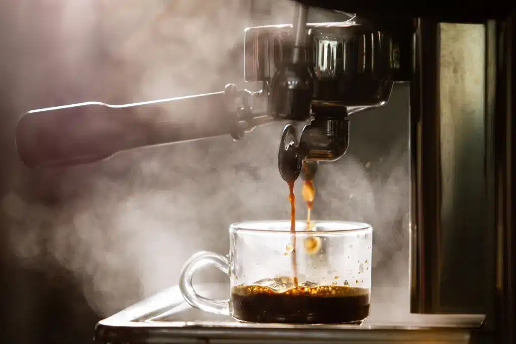 coffee dripping from a machine in a mug 