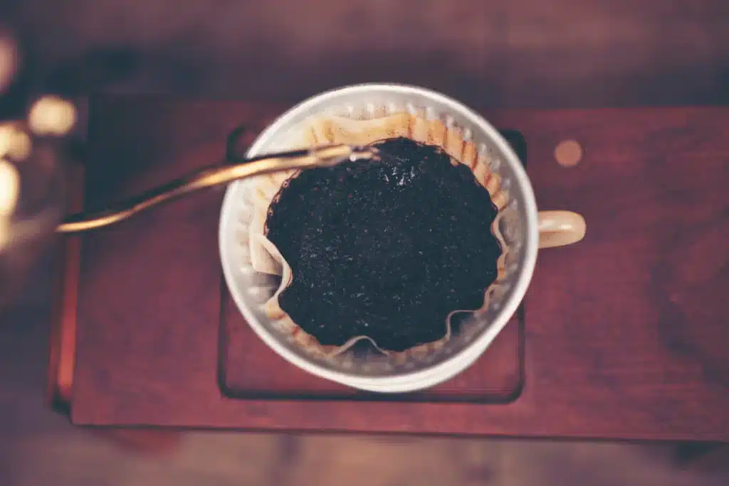 coffee pouring down from filter in the cup