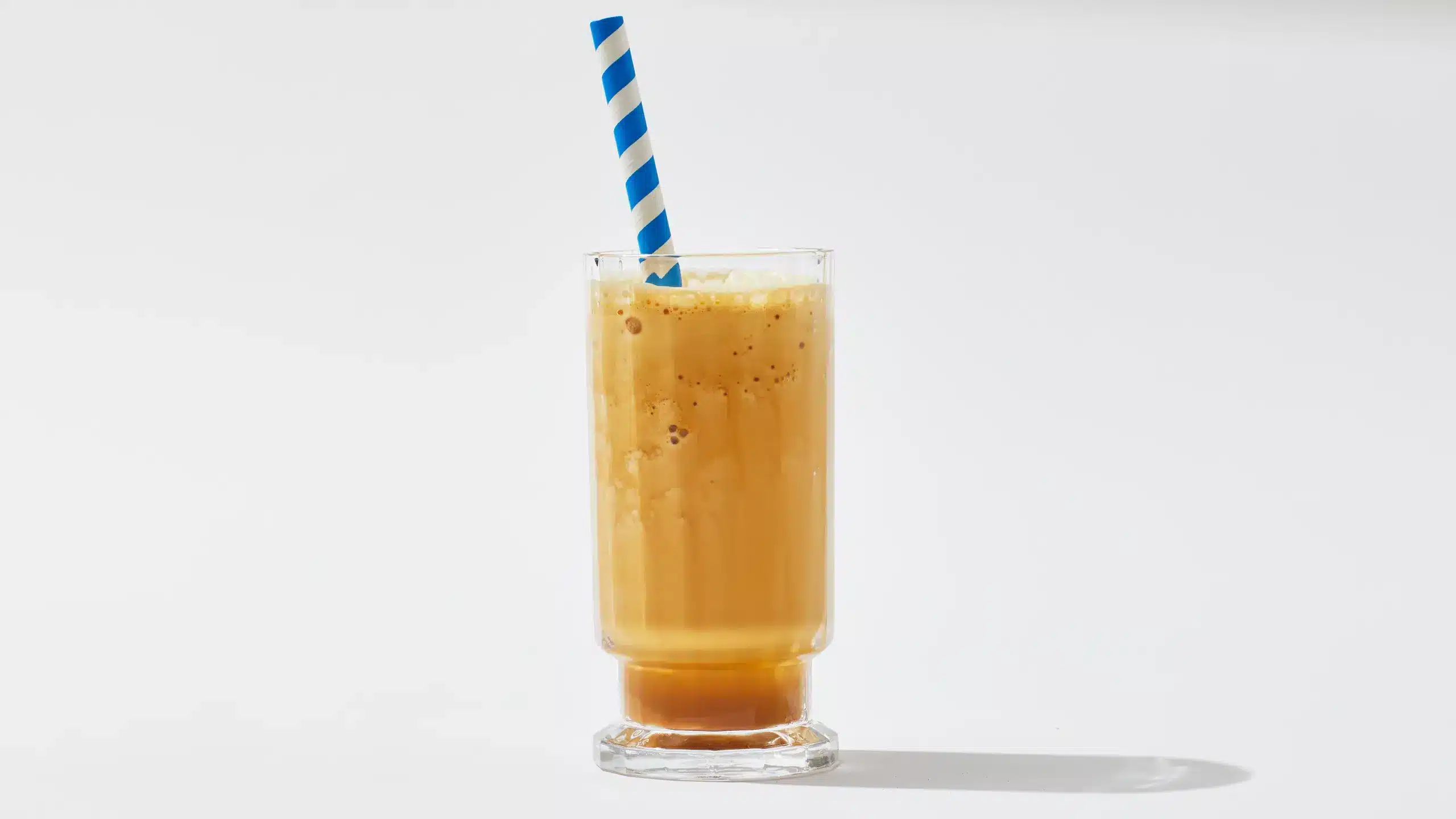 frozen coffee in a glass with a straw