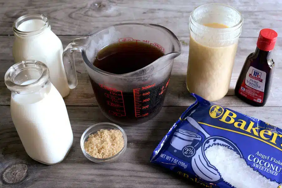 ingredients for frozen coffee brown sugar vannila syrup coconut pack brewed coffee and milk palced on wooden surface