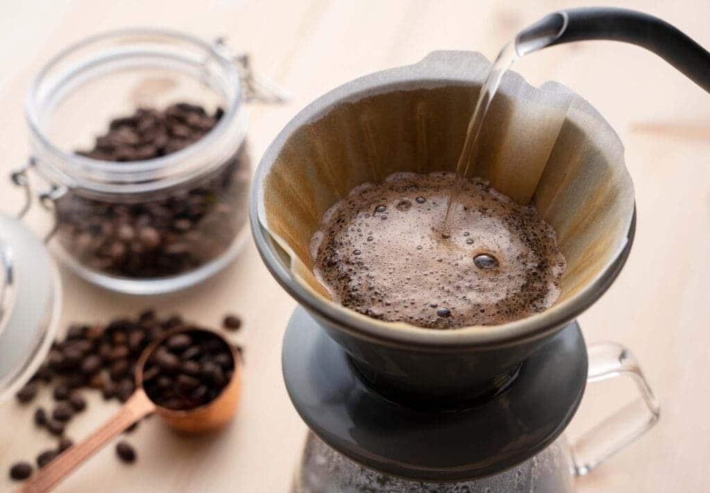 Pour hot water over the coffee powder