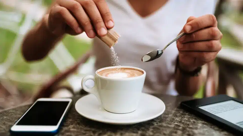 a man adding salt in the coffee