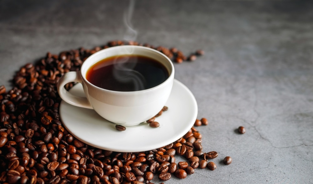 Coffee Cup And Coffee Beans On Gray Background Black Coffee