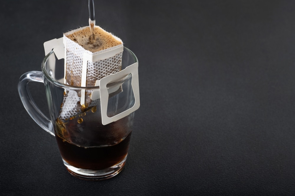 Cup With Drip Coffee Bag On Dark Background The Process