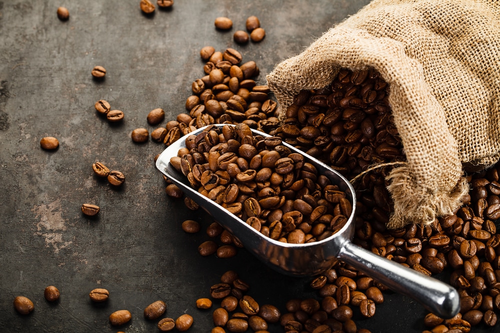 Cup Of Coffee Bag And Scoop On Old Rusty Background